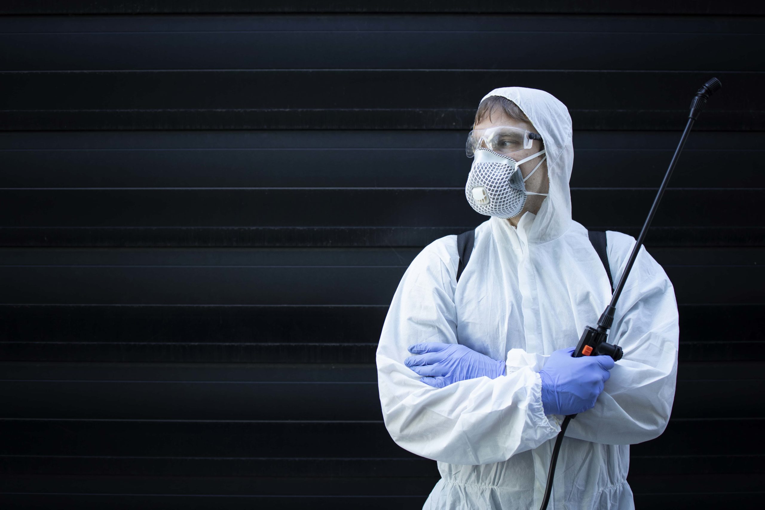 portrait professional exterminator holding sprayer with chemicals pest control
